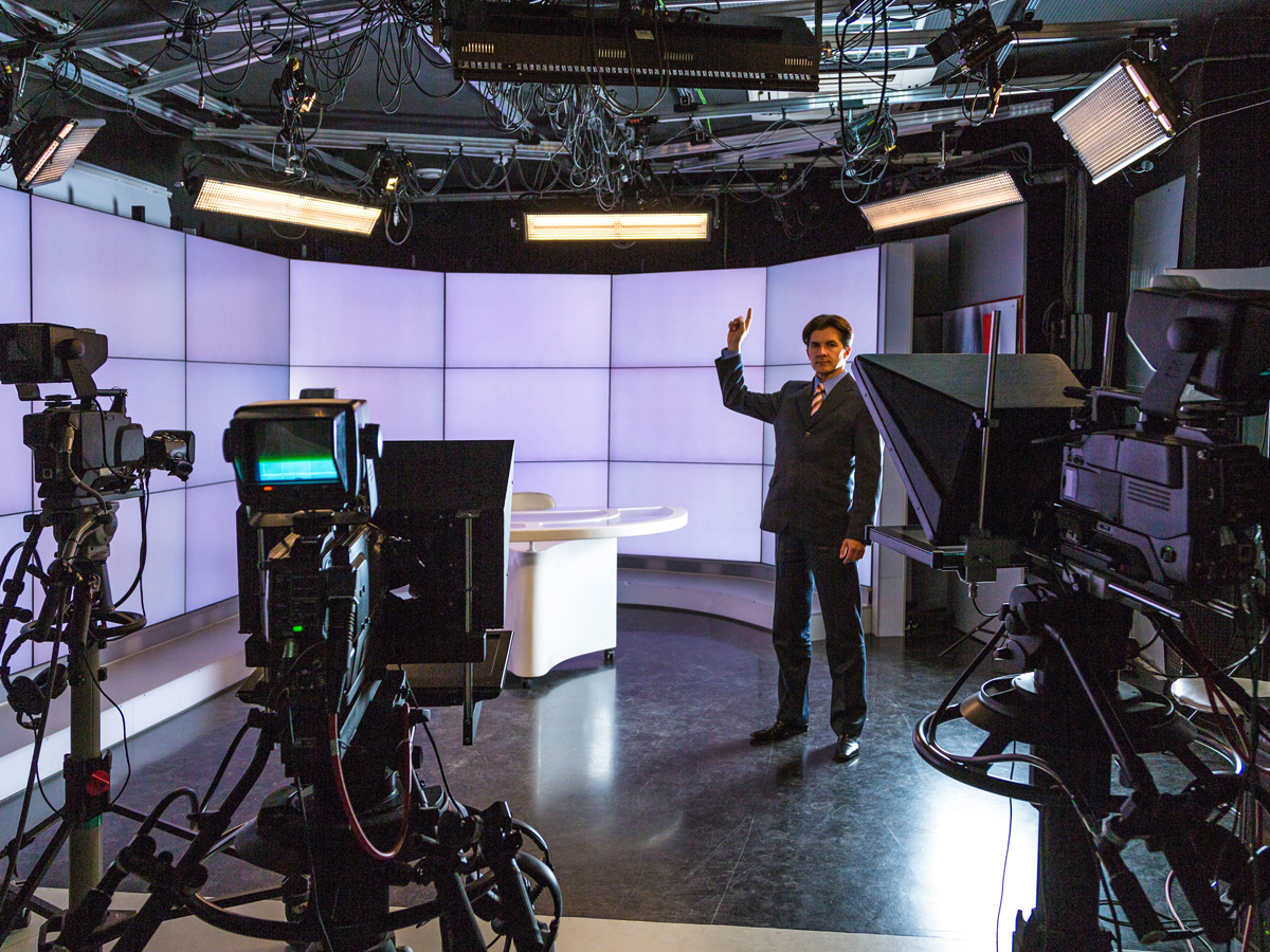 Corporate video production team filming an executive interview on a professional set